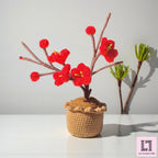 Gehäkelte Blume im Topf Pflaumenblüte