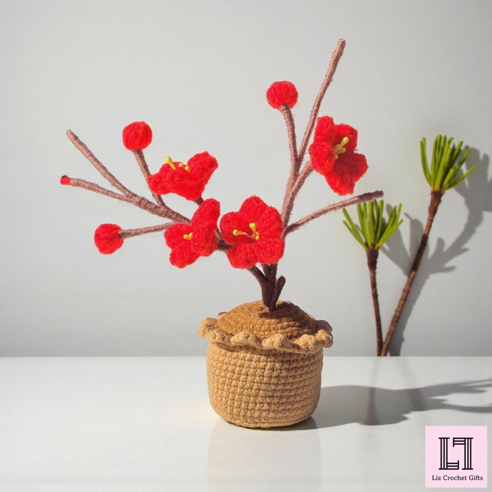 Gehäkelte Blume im Topf Pflaumenblüte